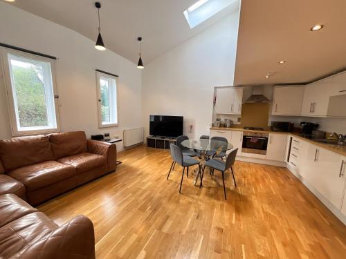 a living room with a couch and a table at Private Parking 2 Bed 2 bath in Edinburgh