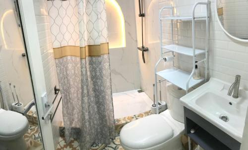 a bathroom with a shower and a toilet and a sink at Compound holiday home - 1 bedroom - Backyard Loft in Wonosobo