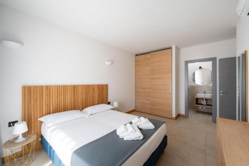 Ένα ή περισσότερα κρεβάτια σε δωμάτιο στο Hotel Delfino