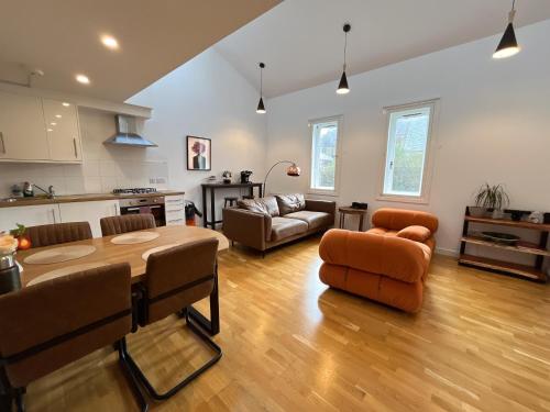 a kitchen and living room with a table and chairs at 2 Bed 2 bath with Private Parking in Edinburgh