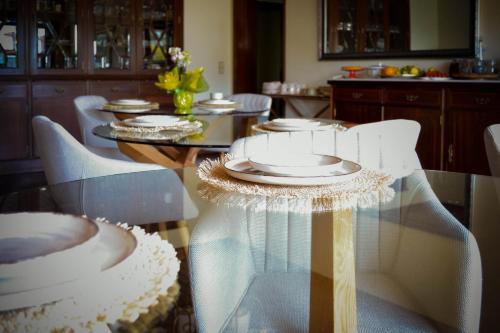 a table with white plates on top of it at SANTA RITA Guesthouse B&B in Vila Nova de Gaia