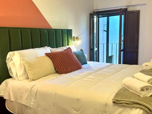 a large bed with two pillows on top of it at Prestige and comfort in the center of Perugia and views in Perugia