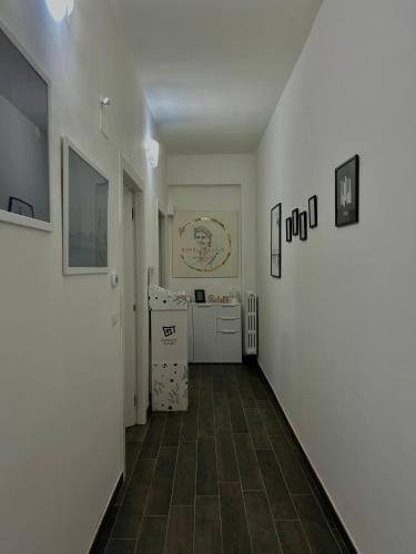 a hallway with white walls and a tile floor at Donna Maria Suite & Relax in Serino