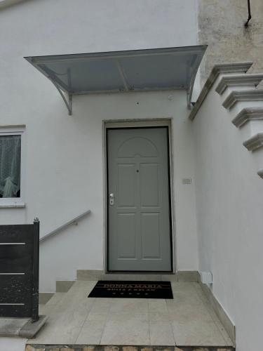 a door on the side of a white building at Donna Maria Suite & Relax in Serino