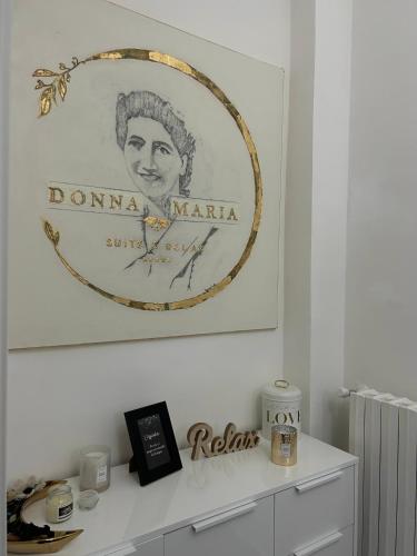 a picture hanging on a wall above a white cabinet at Donna Maria Suite & Relax in Serino