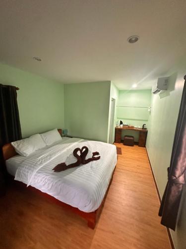 un lit avec une paire de ciseaux marron dessus dans l'établissement Mook Raya Resort, à Ko Muk