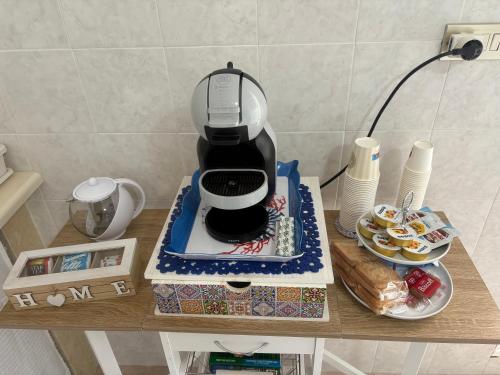 a coffee maker sitting on top of a table at Casa vacanze Santiago e Ian in Maruggio