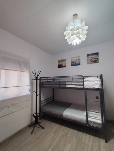 a bedroom with two bunk beds and a chandelier at Isaias house in Rhodes Town