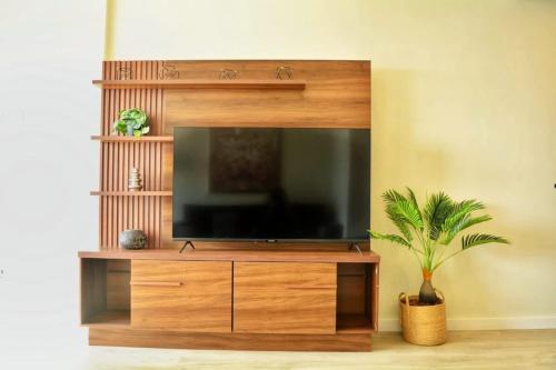 a large entertainment center with a flat screen tv at Hestia at Asuncion Cozy & Bright 1BDR in Caña de Castilla