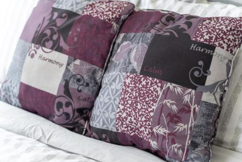a group of pillows sitting on a bed at Beautiful 2BR Apartment-, Walk To West Point, Free Parking! in Highland Falls