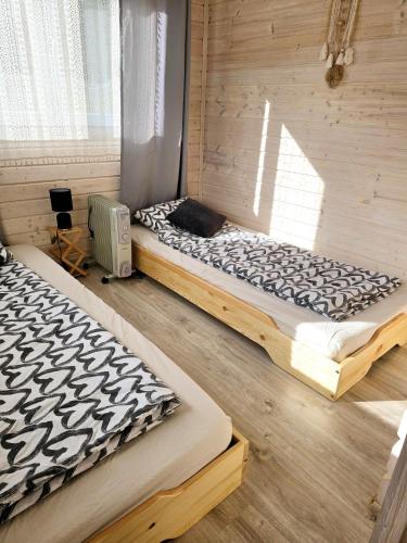 a bedroom with two beds and a window at Mi Casa En Paczyno in Lubawka