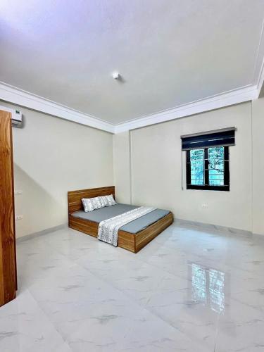 a bedroom with a bed in the middle of a room at WRX guest house in Hanoi