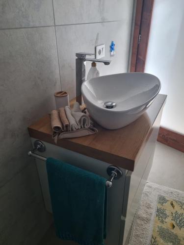 a bathroom with a white sink on a wooden counter at Diongard House in San Vito