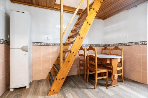 a staircase in a room with a table and chairs at Casa da Muralha in Beja
