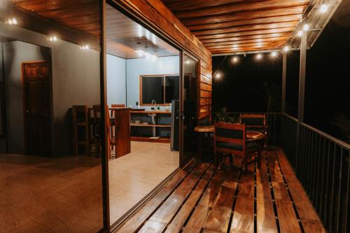 a room with a balcony with a table and chairs at Finca Murillo in Monteverde Costa Rica