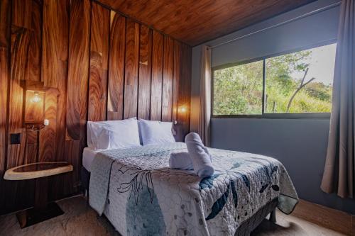 a bedroom with a bed with a window at Finca Murillo in Monteverde Costa Rica