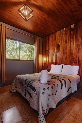 a bedroom with a bed in a room with a window at Finca Murillo in Monteverde Costa Rica