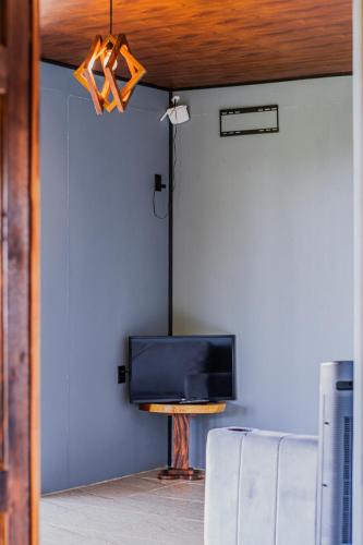 a living room with a tv and a couch at Finca Murillo in Monteverde Costa Rica
