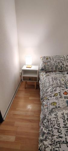 a bedroom with a bed and a nightstand with a table at Casa amplia y confortable in Temuco