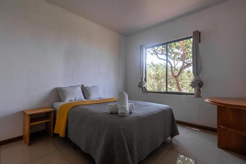 a bedroom with a bed with a stuffed animal on it at Finca Murillo in Monteverde Costa Rica
