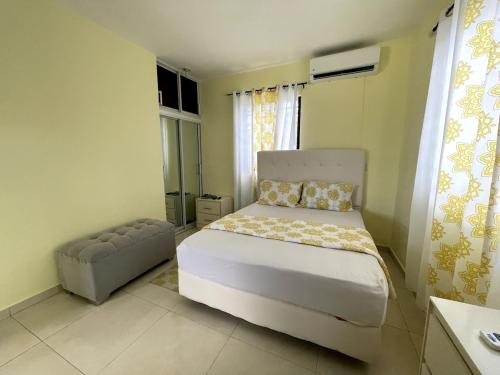 a bedroom with a bed and a chair in it at Apartamento Costero 3 en Las Galeras de Samaná in Las Galeras