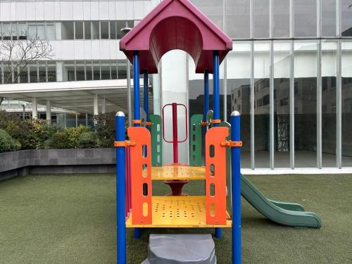 a playground with a slide in front of a building at Centro Banamex Hipódromo de las Américas Toreo in Mexico City