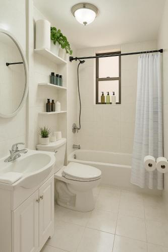 a white bathroom with a toilet and a sink at Lemon Vibes room in New York