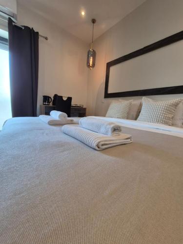 a bedroom with two beds with towels on them at AL Barbinha in Faro
