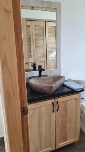 a bathroom with a sink with a large mirror at Casa Azul in Cruz de Huanacaxtle