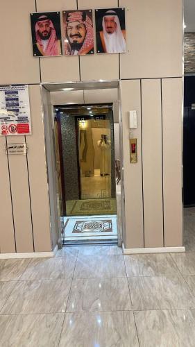a bathroom with a shower with a mirror in it at فندق أمواج روفا in Şāmitah