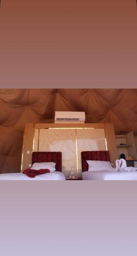 a pair of beds in a room with at Maha Wadi Rum in Wadi Rum