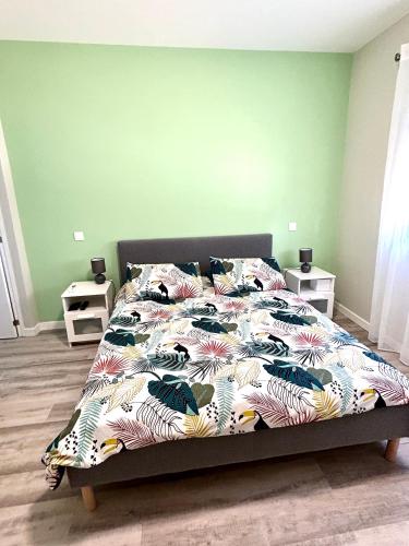a bedroom with a bed with a colorful comforter at Casa Helena in Tavira