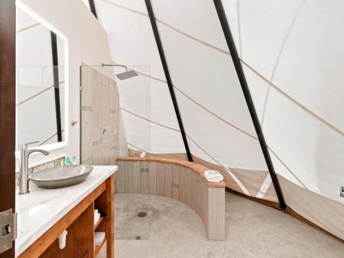 a bathroom with a sink and a mirror at Bluff Dwellings Resort in Bluff