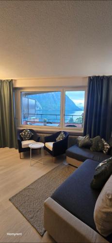 a living room with two couches and a large window at MIRALAGO -Wonderful Lake view in Bissone