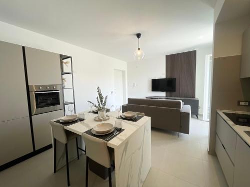 a kitchen and living room with a table and chairs at La Perla del Mare in Anzio