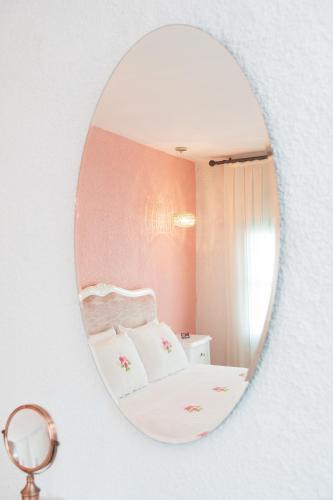 a mirror on a wall with a bed in a room at Sigacik Gardenya Buti̇k Otel in Siğacık
