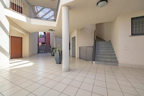a hallway of a house with a staircase and columns at Carthusia View - Affitti Brevi Italia in Certosa di Pavia