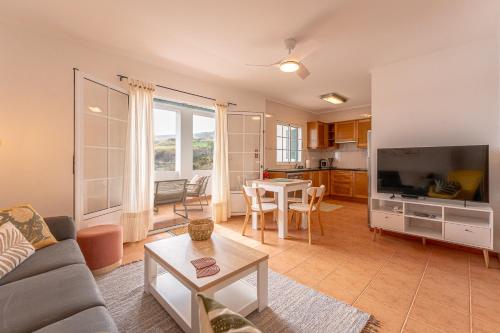 a living room with a couch and a table at Eagle's Perch in Porto Formoso in Porto Formoso