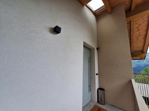 a room with a white wall and a window at Loft Panoramico Valle dei Laghi in Vezzano