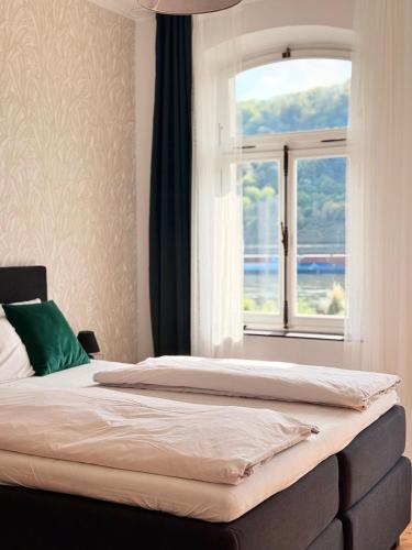 a bedroom with two beds and a window at Villa Rheinblick 1 OG in Kamp-Bornhofen