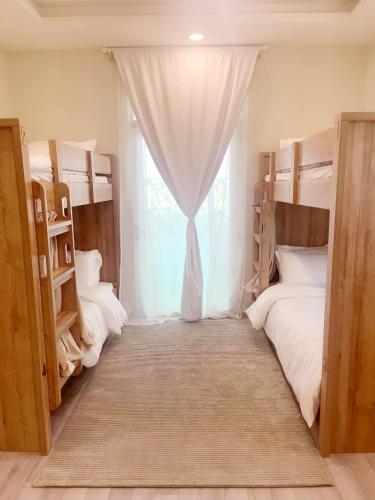 a room with two bunk beds and a window at Luxury apartment with balcony, City view in Jeddah