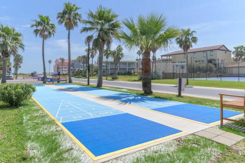 a basketball court with palm trees on a street at Tiki SPI Beachfront Condo, RIGHT ON THE BEACH! in South Padre Island