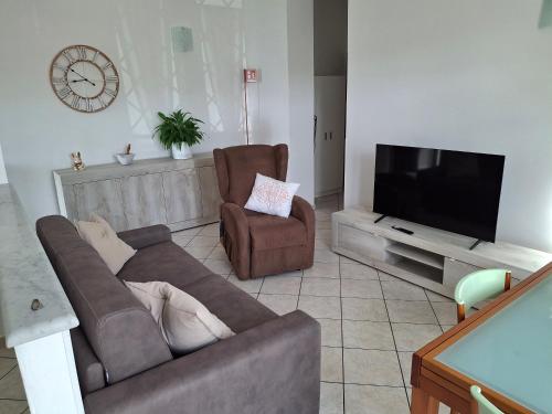 a living room with a couch and a flat screen tv at A Casa di Lidia in Sarzana