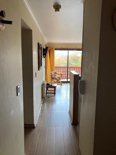 a hallway of a house with a view of a living room at DEPARTAMENTOS TERMAS DE CHILLAN in Nevados de Chillan