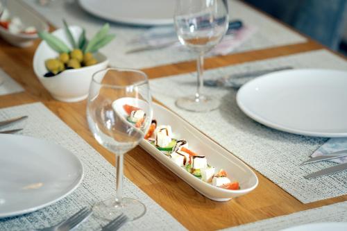 a table with a tray of food and wine glasses at EMP Luxury Rental in Jelsa