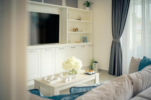 a living room with a tv and a coffee table at EMP Luxury Rental in Jelsa