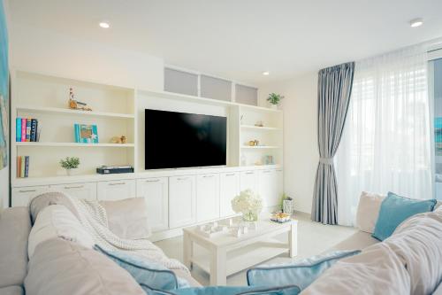 a living room with a couch and a tv at EMP Luxury Rental in Jelsa