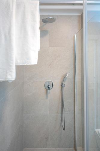 a bathroom with a shower with a glass door at EMP Luxury Rental in Jelsa