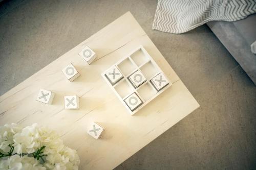 a wooden table with dice and flowers on it at EMP Luxury Rental in Jelsa