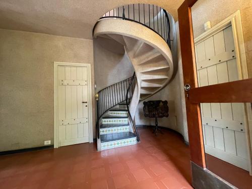 a spiral staircase in a room with two doors at Villa a Rocchetta Luxury Guesthouse in Monterosso al Mare